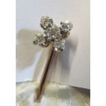 A stick pin set five diamonds