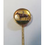 A yellow metal stick pin with reverse painting on glass jockey and horse engraved Arulo 1898 to
