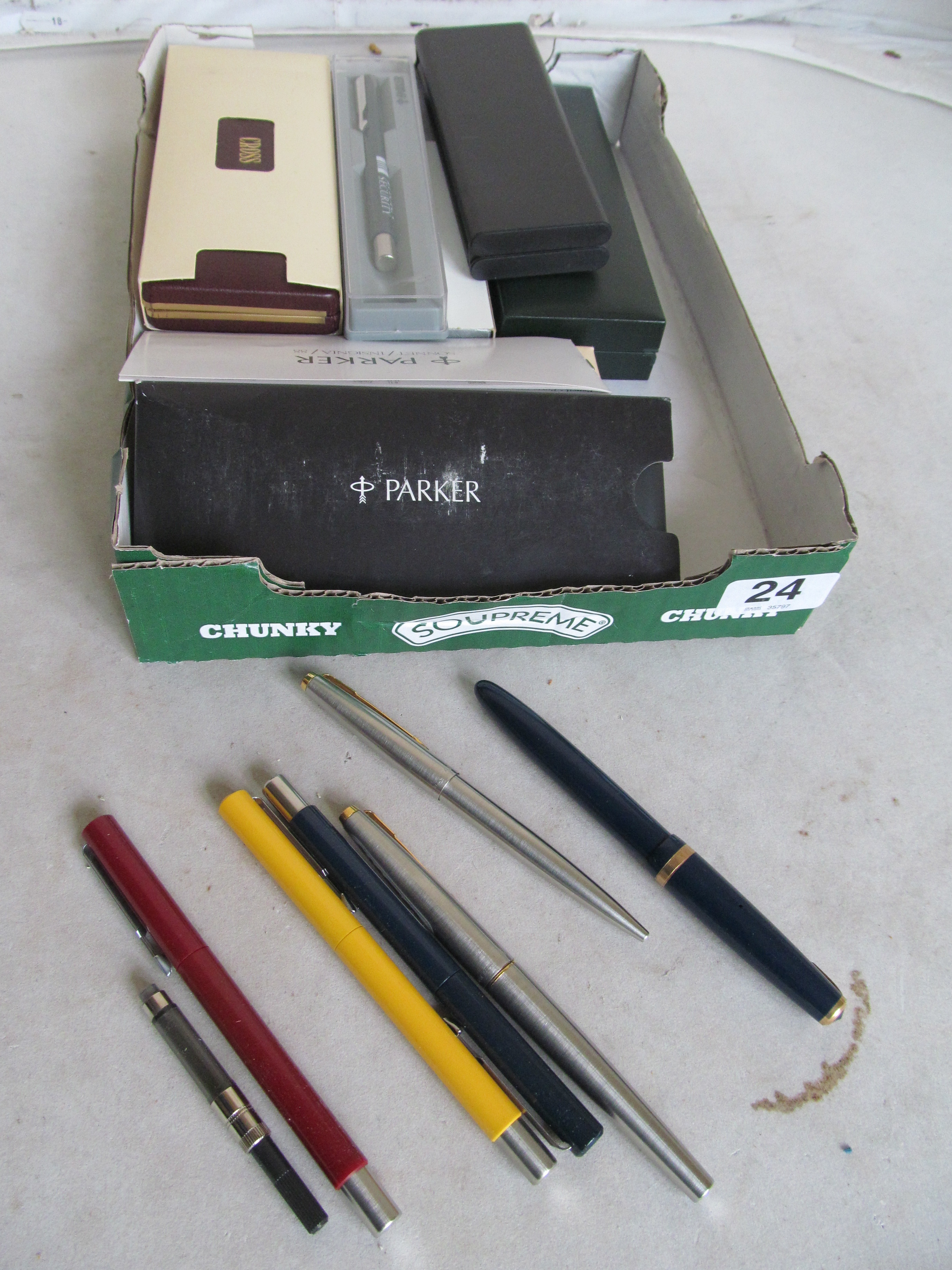 A black Parker pen and various Cross pens (all boxed) and other pens (unboxed)