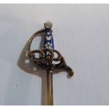 A yellow metal stick pin in the form of a sword with enamel and diamond hilt (i.c.)