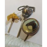 A yellow metal stick pin horses head, silver stick pin jockey cap and whip and another transfer