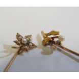 A yellow metal stick pin set seed pearl and diamond leaf and berries and a seed pearl stick pin