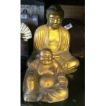 A brass Buddha and another