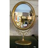 An Art Nouveau style brass swing mirror with lady to side