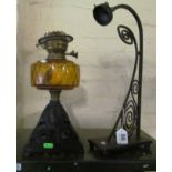 An Art Nouveau style lamp and an oil lamp