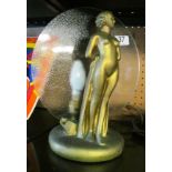 A gilt Art Deco lamp with circular glass disk and nude figure lady