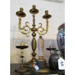 A brass three branch candlestick, two brass bells and a small pair candlesticks
