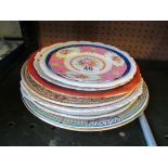 Various decorative plates, a pottery cat et cetera