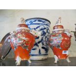 A pair of Japanese lidded vases iron red ground and floral with kylin lions to lid and sides and a