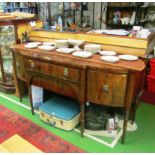 A Regency string inlaid mahogany bow front sideboard on turned legs