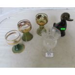 A glass duck and four glasses
