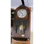 An oak wall clock, dome top, eight day chiming and striking