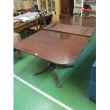 An antique mahogany 'D' end dining table on later twin pedestals and two leaves