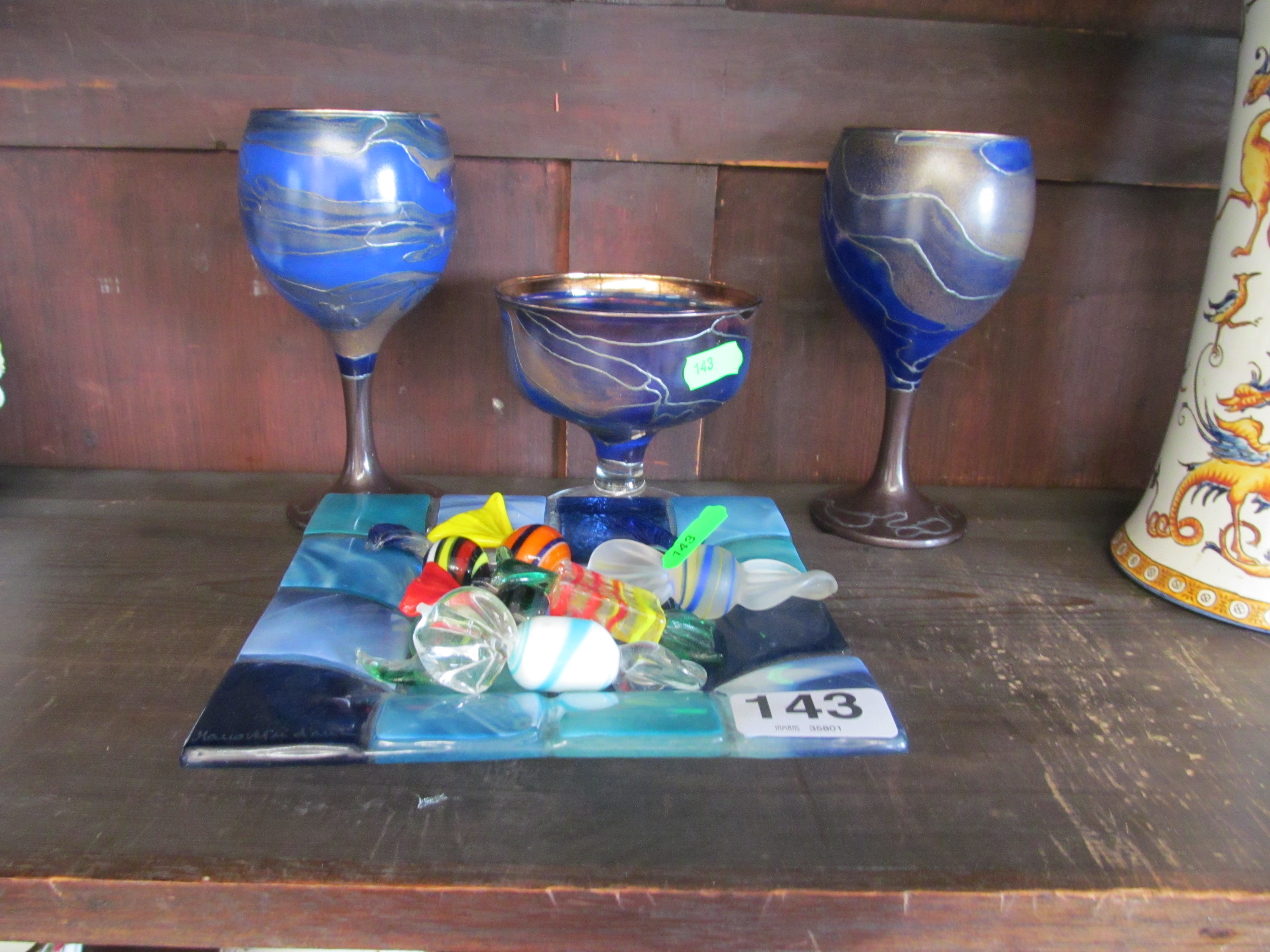 A glass dish and sweets and three glasses