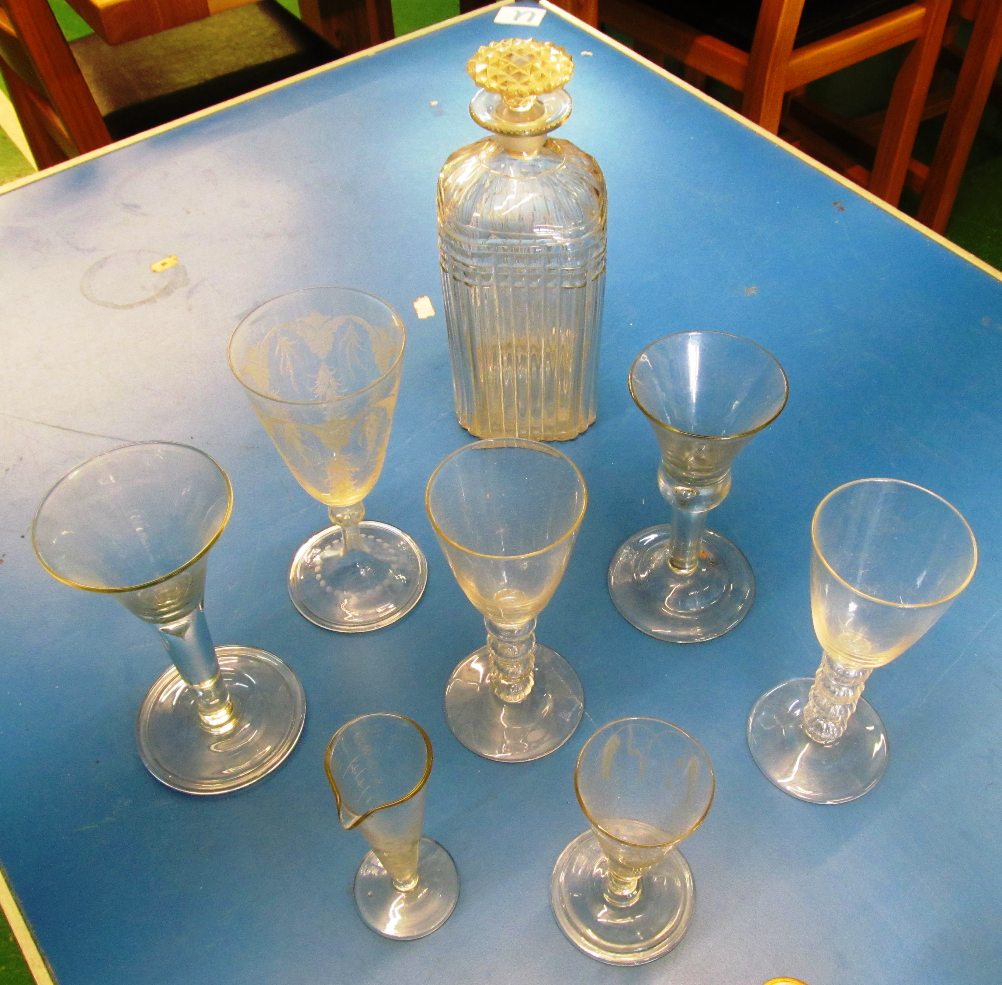 A Georgian glass decanter and stopper, engraved Brandy, four antique glasses and a measure