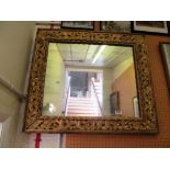 A gilt frame floral mirror