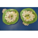 A pair of mid 19th Century porcelain dessert dishes painted with flowers against and apple green