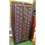 An eastern painted two door cabinet with floral lattice panels