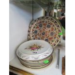 A Victorian floral bread plate, six Bodley floral and butterfly plates and a floral pottery plate