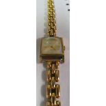 A ladies gold watch on 18ct gold strap