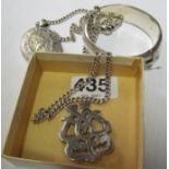 A silver bangle, locket on chain and other silver