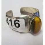 A beaten silver and tigers eye bangle bracelet