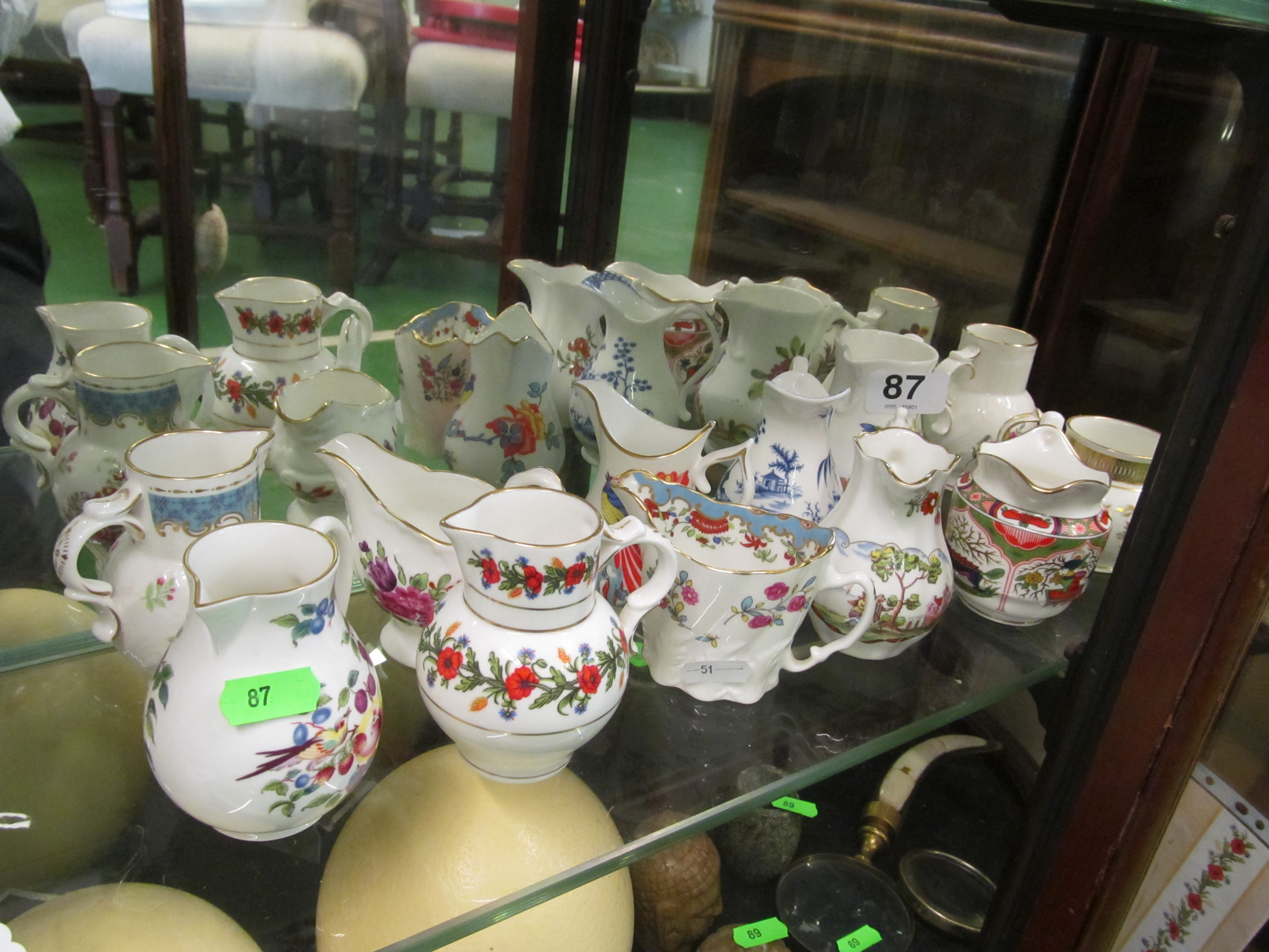 Twelve Royal Worcester ironstone jugs and shelf unit with centigrade