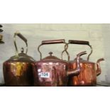 Two copper kettles and copper and brass kettle.