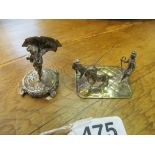 A miniature silver cherub holding an umbrella and a goat herder, both marked Saunders & Shepherd
