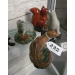 Four Beswick animal whisky flasks with contents - otter, seal, badger and squirrel