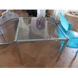A chrome glass top square table