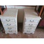 A pair of four drawer bedside chests.