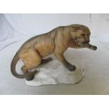 A Beswick lioness crouching on rock No.1702