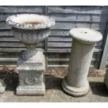 A reconstituted stone garden urn on pedestal and a pillar