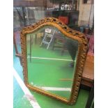 A gilt framed arched wall mirror