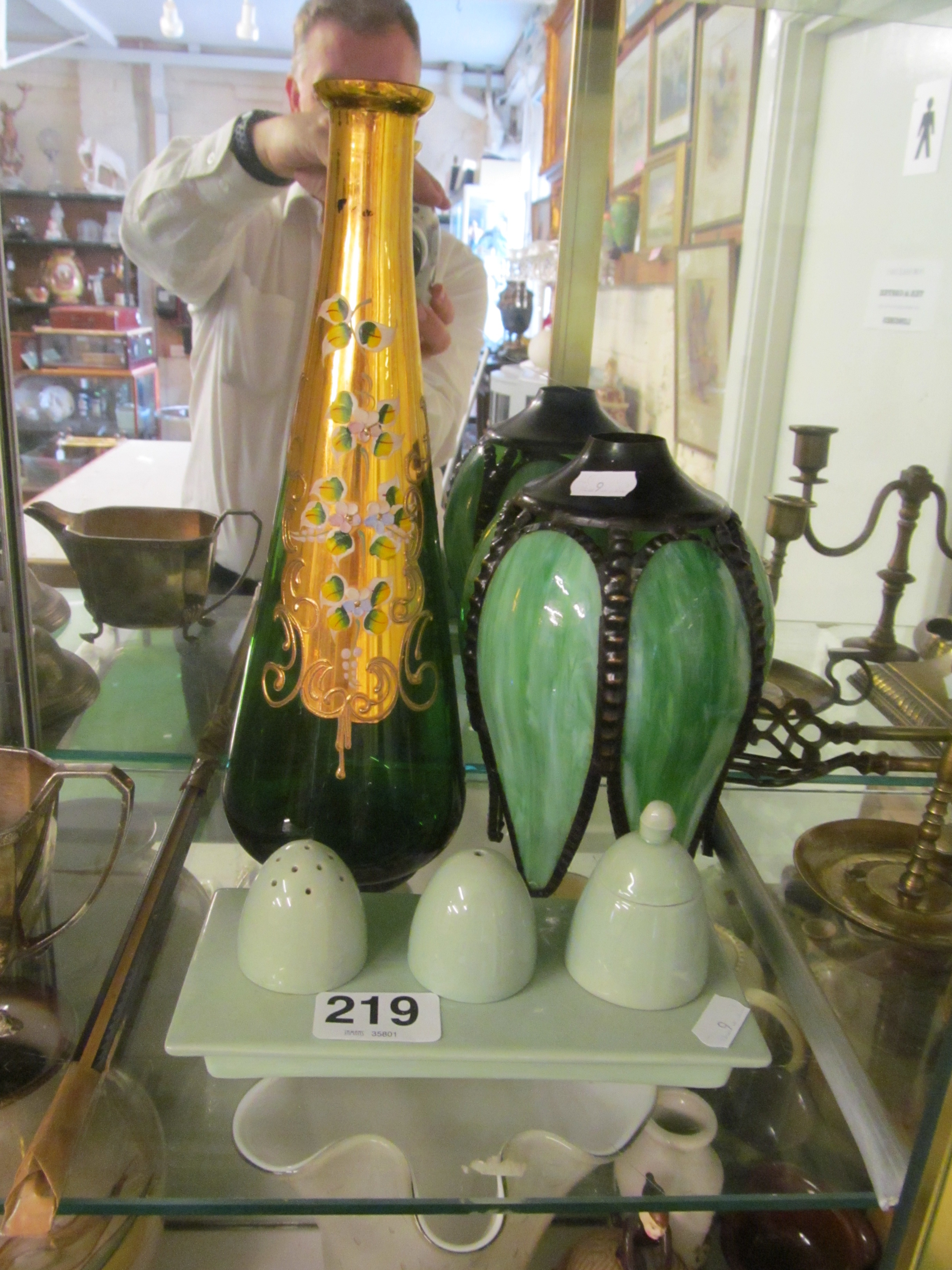 A green pottery condiment stand, green petal shade and green and gilt Venetian glass decanter (no