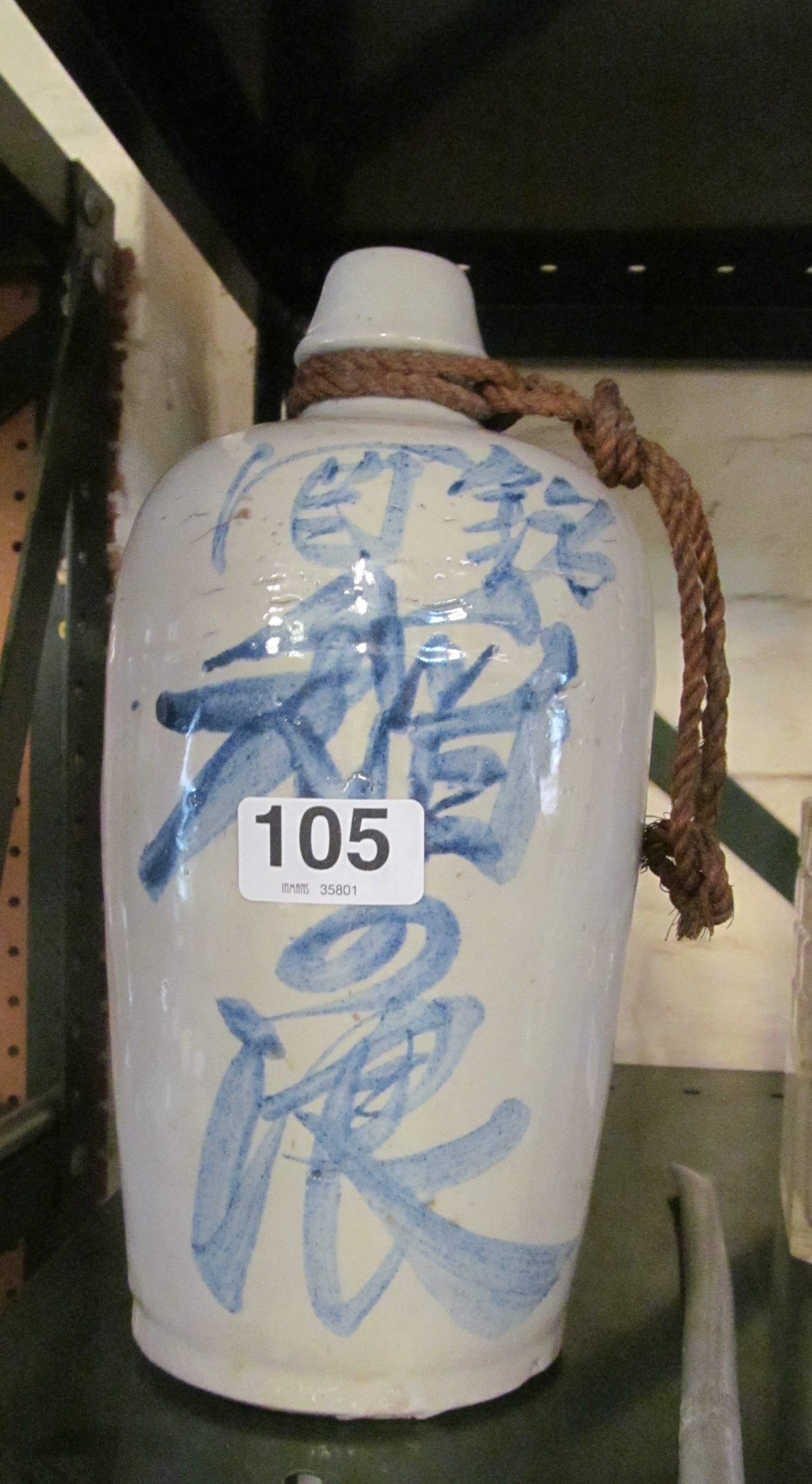 A stoneware pottery Oriental bottle with blue design