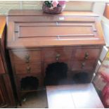 An oak bureau with five drawers