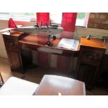 An Edwardian mahogany twin pedestal sideboard, two central drawers, drawer and cupboard to