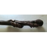 A Victorian umbrella with carved handle of two bearded men in tree trunk