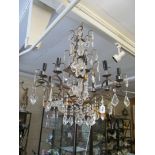 A metal and lustre drop twelve branch chandelier