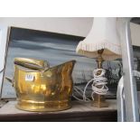 A copper coal bin and lamp