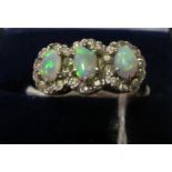 An 18ct gold three stone opal and diamond cluster ring
