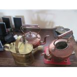 A brass watering can and two copper kettles