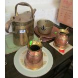 A brass watering can, two jugs, pan and copper plate