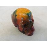 A small amber coloured skull