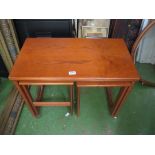 A H. McIntosh teak table with two tables under.