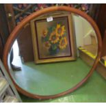 A large oak circular mirror