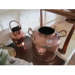 A copper two handled pot and copper twin spout jug