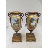 A pair of gilt metal two handled garniture vases with enamelled scene of landscapes with cattle